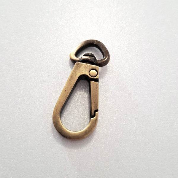 Bronze colour metal clip on a white background