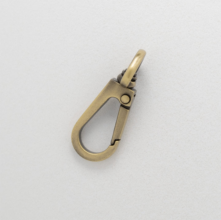 Bronze-colored metal clasp on a light gray background