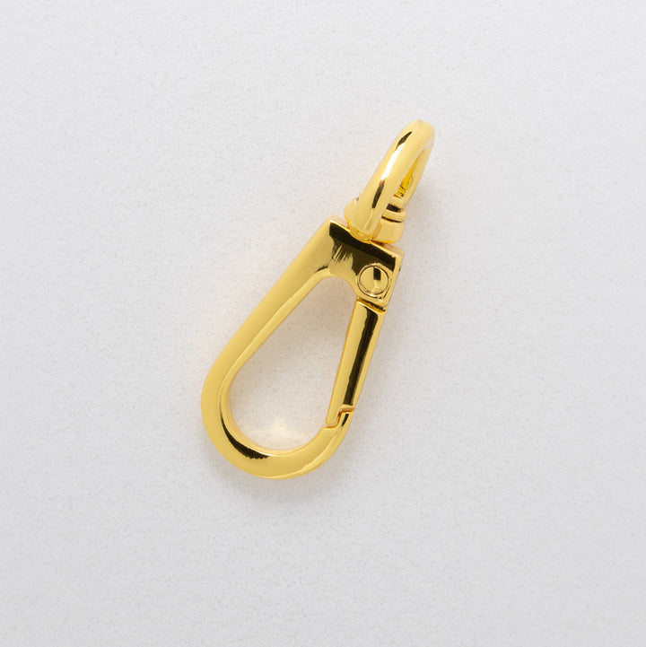 Gold carabiner on a white background