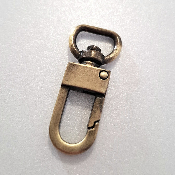 Antique brass dog clip on white background