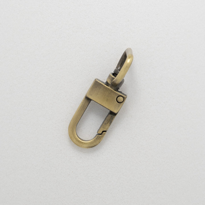 Antique brass dog clip on white background