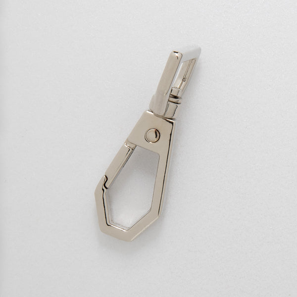 Nickel coloured dog clip on a white background