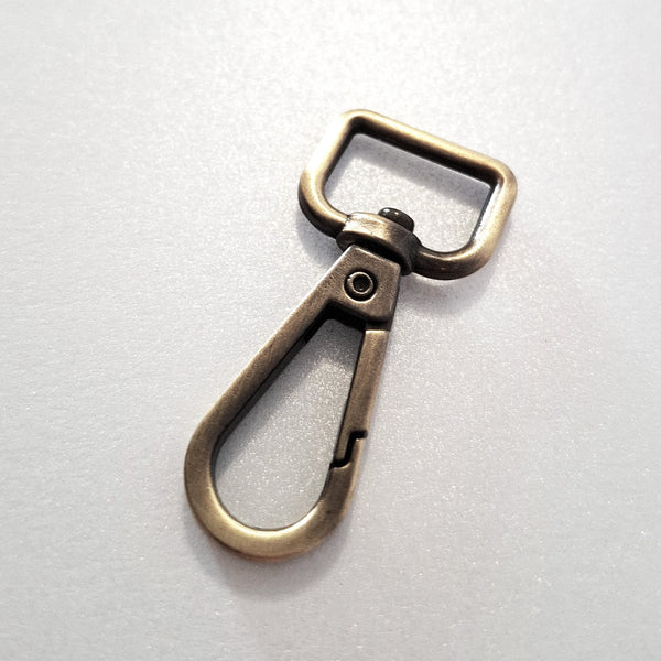 16.5mm antique brass dog clip on white background