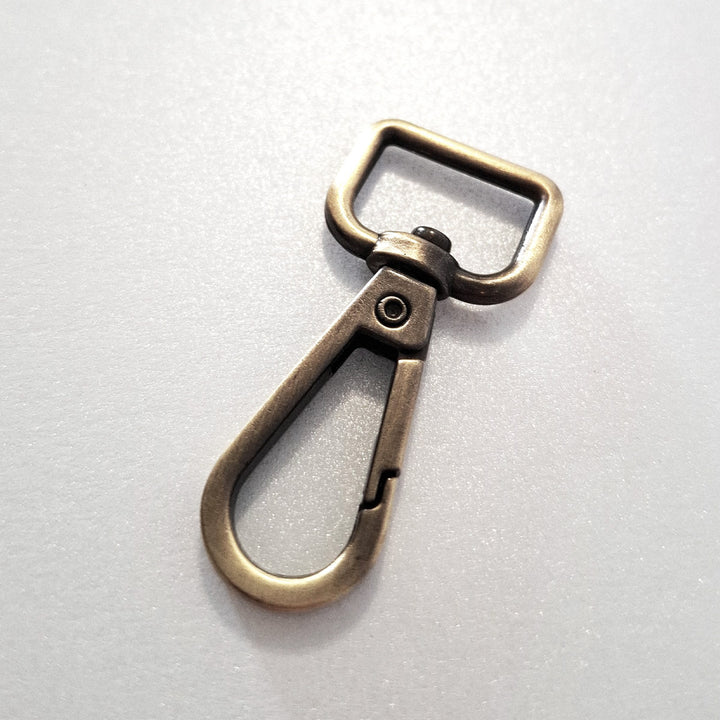 16.5mm antique brass dog clip on white background