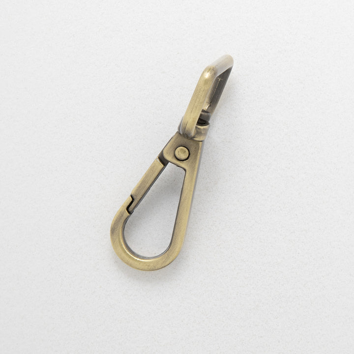 16.5mm antique brass dog clip on white background